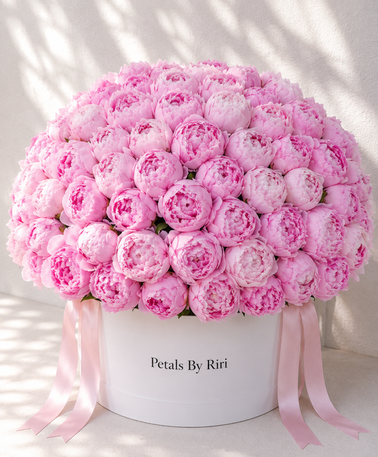 100 pink peonies luxury hatbox arrangement – Petals by Riri Dubai
