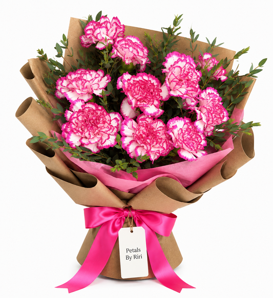 Pink and white carnation bouquet wrapped in coffee brown paper with pink satin ribbon by Petals By Riri